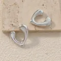 Close-up detail of irregular heart-shaped silver C-hoop earrings on stone texture background. - Irregular Heart C-Shaped Style (A24-049R) / Silver