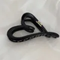 Close-up view of a matte black heart hair claw clip featuring elegant gold text details. - Heart Gold-Labeled Hair Claw / Black