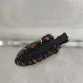 Close-up of a colorful woolen knitted hair clip, textured fabric detail on black duckbill. - Seamless Clip / Black