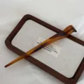 New Chinese style amber acetate hairpin detail shot, elegant daily hair bun accessory for women. - Caramel color