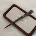 Elegant acetate hair stick detail, vintage tortoiseshell pattern for chic chignon styling. - Black and Gray