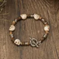 Vintage turquoise skull and coconut shell wood bead bracelet, detailed shot on dark wood. - White Turquoise Texture Skull Style