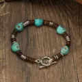 Close-up of the vintage turquoise skull wooden bead bracelet, boho style unisex jewelry. - Turquoise Texture Skull Style