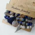 Detail shot of multi-layer bohemian beaded bracelet with tassel and wing pendant, vintage style. - Regular Style (B23-432)