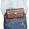 Close-up detail of a brown leather waist phone pouch with metal lock buckle worn on jeans. - 4.7 Inch / Dark Brown