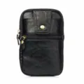 Close-up detail of black leather waist bag with double zippers, snap button and textured finish. - Black / 6.5 Inch