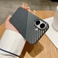 Detailed shot of a stylish diagonal patterned phone case with dual camera cutout held in hand. - iPhone17 / Black And Silver