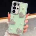 Detailed view of the sparkling green phone case featuring rhinestone hearts and elegant pearls. - Glitter Light Green and Pearl Heart (S26)