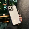 Detailed lifestyle view of transparent phone case with metal buttons and protection. - iPhone17 / Transparent Black