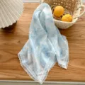 Blue floral triangular headscarf with delicate white lace border, retro vintage style hair accessory. - Coconut Rainforest Blue and White