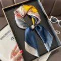 Elegant silk scarf in dark blue with yellow feather print, stylish accessory for women. - Butterfly Feather