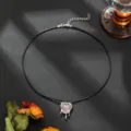 Detailed view of the gothic punk lava heart pendant necklace on black cord, unique design. - Pink