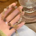 Detailed close-up shot of the multi-color rutilated quartz crystal bracelet showcasing beads texture. - Rutilated Quartz Shell Pendant Style