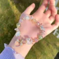 Crystal beaded bracelet with heart pendant and bow charm, sweet forest style detail shot. - Pink Green Series