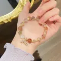 Stunning crystal bracelet featuring strawberry quartz, cute clover charms, and mermaid tail pendant. - 3 Multicolor Rutilated Quartz