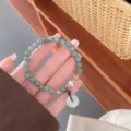 Close-up detail of Chinese style retro green jade bead bracelet with safety buckle pendant. - Jadeite Ping'an Buckle