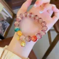 Detailed shot of a colorful glazed bead bracelet with cute golden pixiu charm for women. - Purple Series