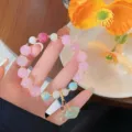 Close-up detail of the pink crystal lotus beaded bracelet, featuring exquisite carved floral beads. - Pink Crystal And Ruyi