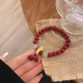 Bracelet de perles de cinabre rouge style chinois avec éléphant et boucle de jade. - Style Anneau Éléphant Imitation Ambre