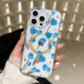Clear phone case detail view showing blue floral pattern and gold magnetic ring design. - C5 Style (iPhone17)