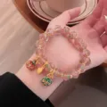 Detailed view of sweet fairy style glass rose beaded bracelet with cute enamel charms. - Rose Glass Bracelet / Hibiscus Pink