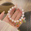 Sweet pink glass rose beaded bracelet with gold spacers and cute festive lion charms for women. - Pure Love Pink