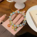 Colorful glazed bead bracelet with sweet charms, golden spacer beads, and elegant style. - Peacock Feather Yellow Blue