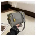 Grey leather crossbody bag for women, stylish small square bag with wide strap and gold hardware. - Gray