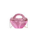 Glossy pink acrylic handbag detail view, showing the woven texture and metal chain strap. - Pink