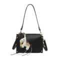 Black leather crossbody bag with cute horse charm and gold hardware, stylish and chic. - Black With Pendant