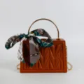 Brown structured box handbag with chain strap, metallic top handle and stylish printed silk scarf. - Red