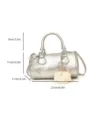Silver metallic boston handbag detail view, compact crossbody bag with cute plush charm. - Silver with Charm