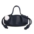 Navy blue leather handbag with cute white fluffy pom-pom and stylish side knotted drawstrings. - Dark Blue