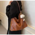 Stylish soft leather shoulder bag for women, casual hobo dumpling bag with chain. - Brown with Pendant