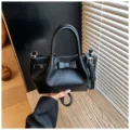 Black leather bucket bag for women, stylish handbag with bow knot and shoulder strap. - Black