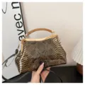 Vintage snakeskin pattern kiss-lock handbag with top handle and detachable shoulder strap. - Gold