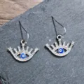 Stunning rhinestone evil eye earrings featuring a stylish blue and white design for women. - Eyelash Round Eye Silver Style (A24-262R)