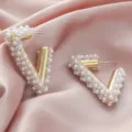 Close-up of geometric V-shaped pearl rhinestone earrings detail showcasing luxury style. - Geometric V-Shape White Artificial Pearl & Multicolor Rhinestone Style (A24-299F)