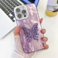 Detail view of the purple glitter phone case featuring a unique butterfly stand and lens protection. - Crinkled Purple With Butterfly Stand / iPhone 13