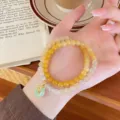 Close-up detail of the double-layer natural agate bracelet featuring a jade peace buckle charm. - Gradient Quartzite Jade