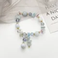 Superbe bracelet de perles en cristal de fée avec de jolies pierres bleu clair et des charms. - Gland en Pierre Bleue / Bleu