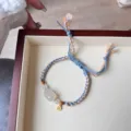Tibetan ethnic braided pull bracelet with jade Pixiu charm and gold coin pendant for women. - White Agate Pi Xiu