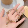 Detailed view of the Chinese style Pixiu and sunstone crystal bracelet with adjustable chain. - Sunstone