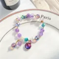 Magnifique bracelet en perles de cristal avec des pierres multicolores et de fins charms. - Rond / Violet améthyste
