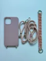 Pink silicone phone case with long woven lanyard and short acrylic chain variant for iPhone. - Sand Pink