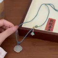 Chinese style white agate ruyi pendant necklace featuring blue braided rope and elegant beads. - Haze Blue