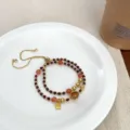 Double-layer crystal beaded bracelet featuring lucky charm and adjustable gold chain. - 1 Garnet and Sansheng
