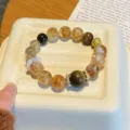 Natural crystal multi-treasure bracelet detail, featuring citrine, smoky quartz, and gold accents. - White Agate Ring Style