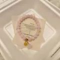 Natural pink crystal beaded bracelet with sweet pink pendant and elegant paper card design. - Lotus Seed Pod Style