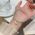 Close-up detail of the sweet pink crystal and pearl charm bracelet featuring a cute pony. - Rocking Horse